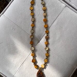 Elegant Necklace handmade with Amber-like beads.